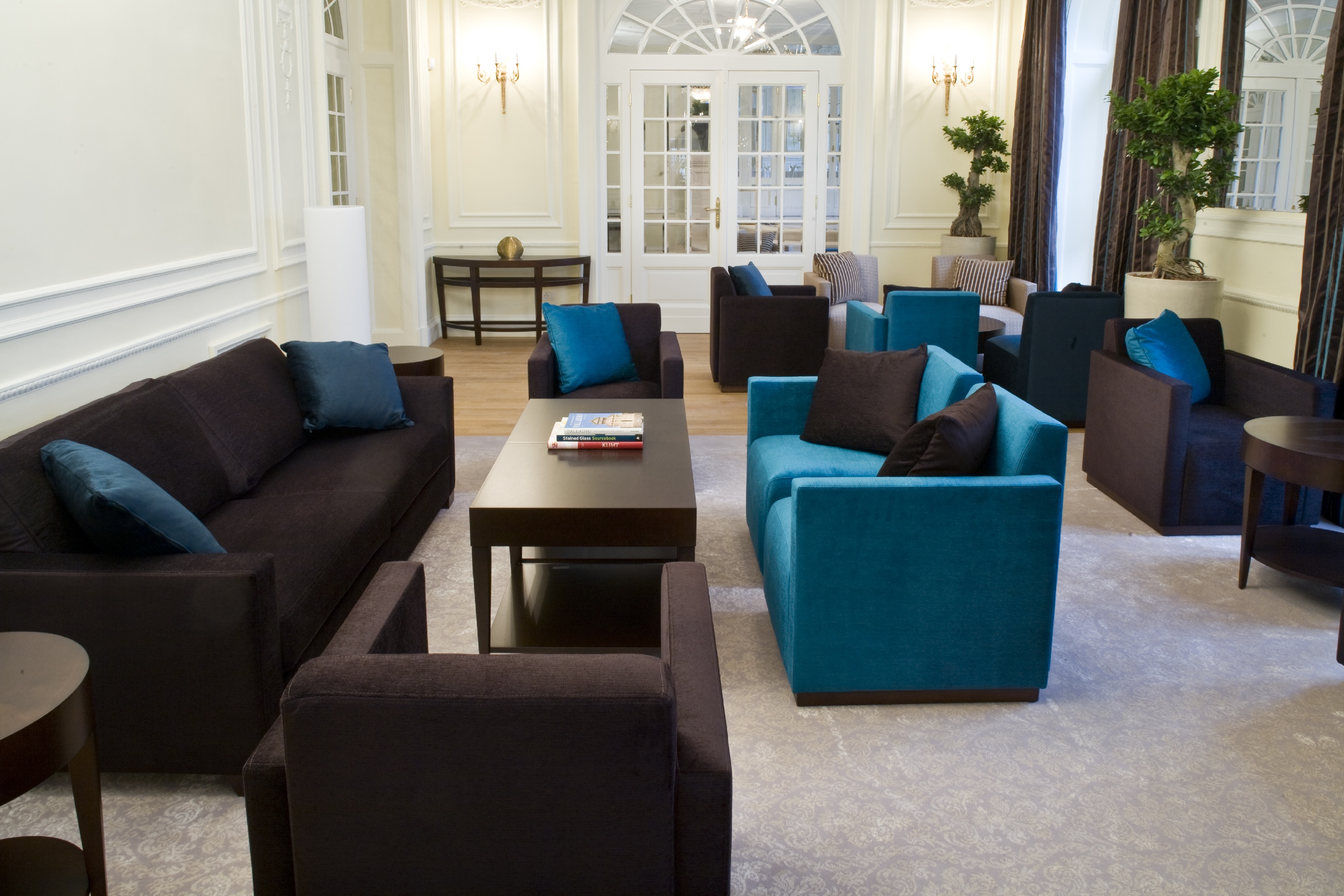 a room with blue couches and coffee table