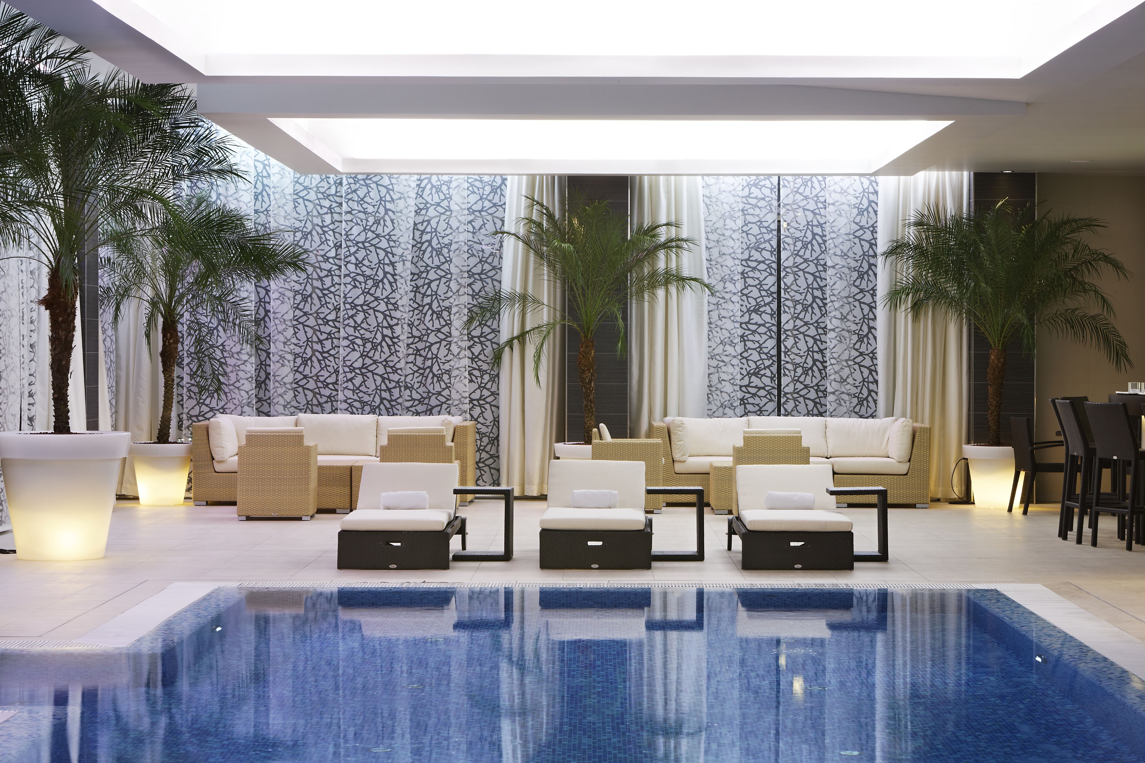 a pool with chairs and a couch
