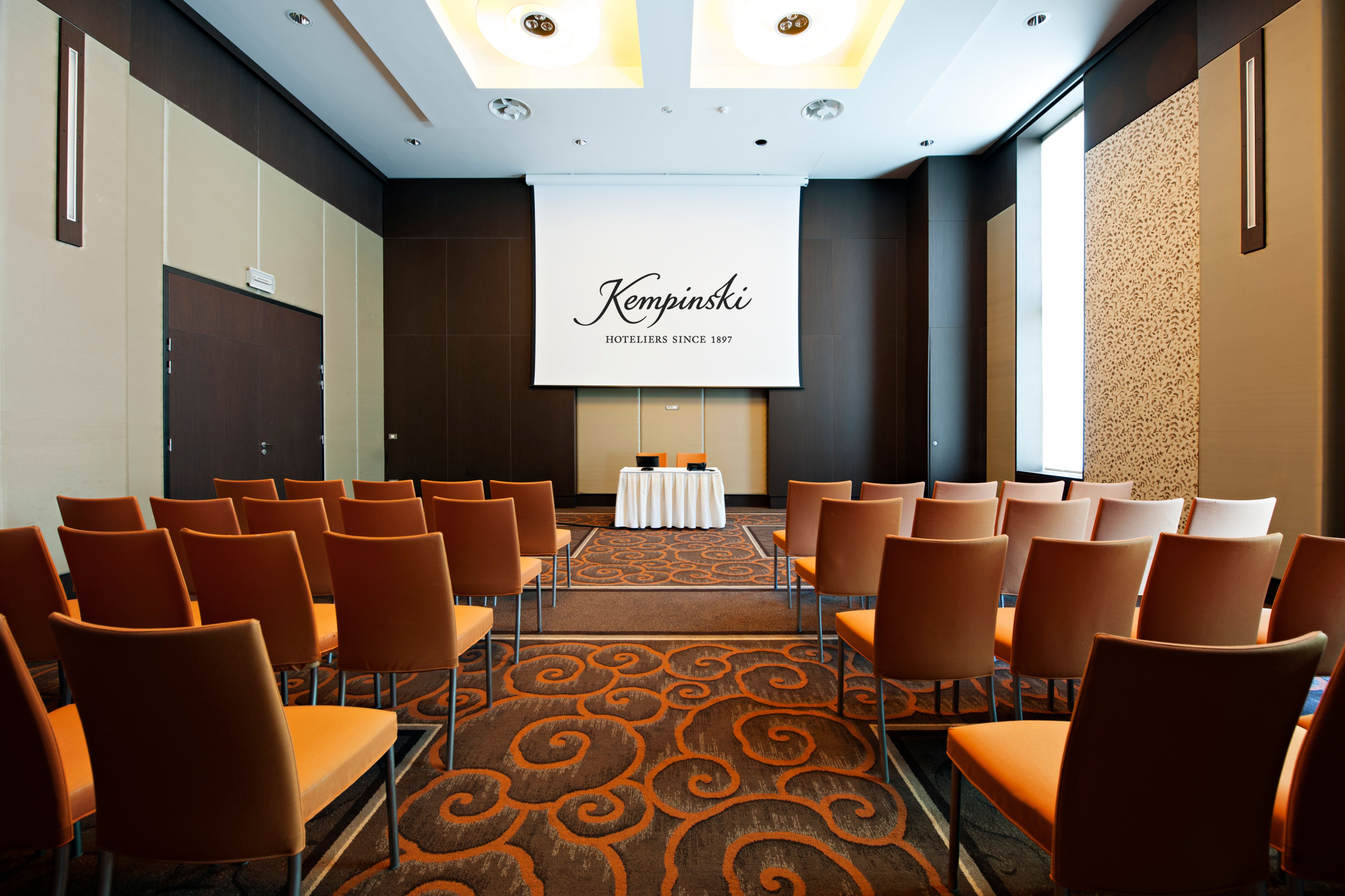a room with chairs and a projector screen