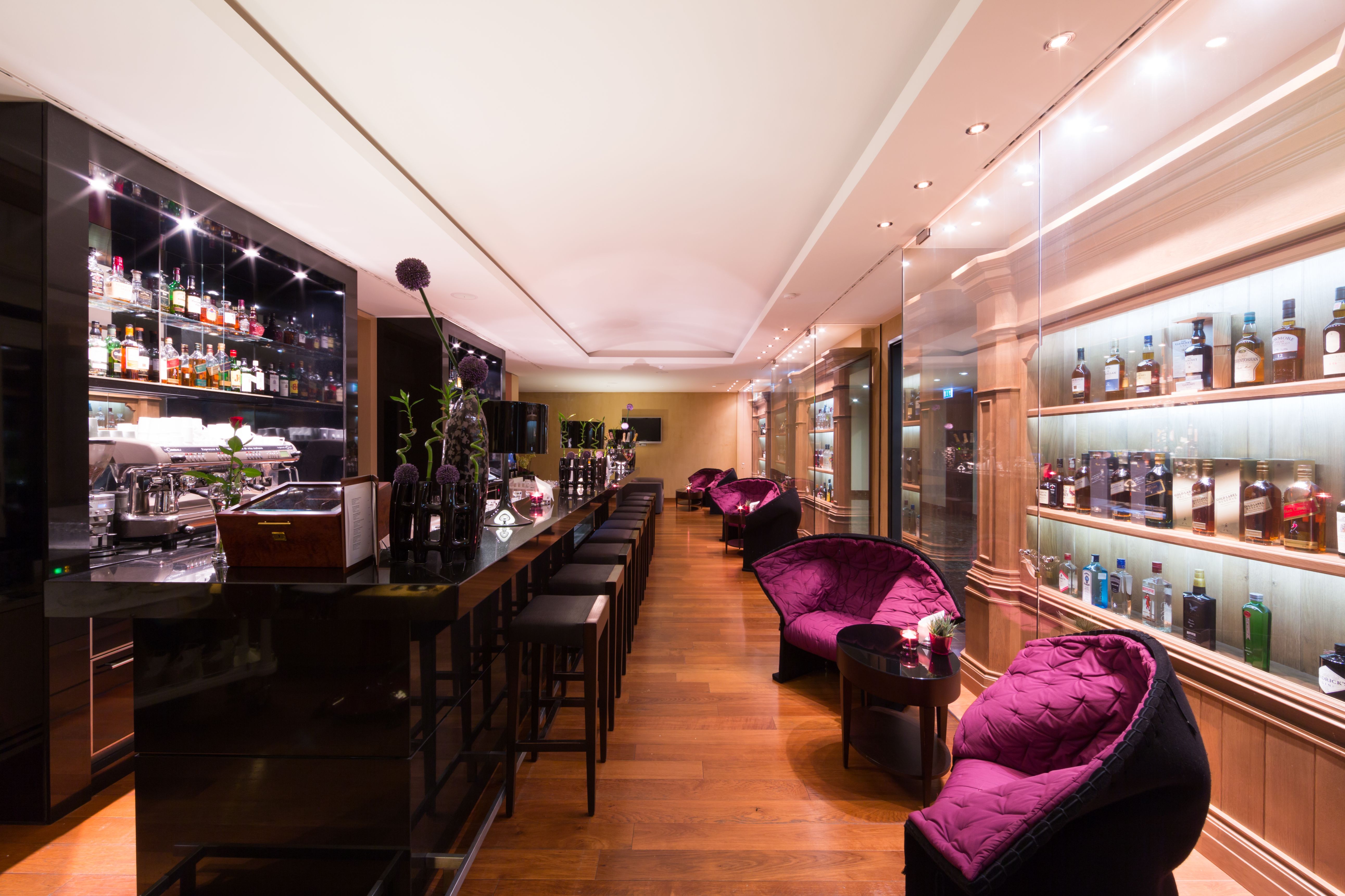 a room with a bar and chairs