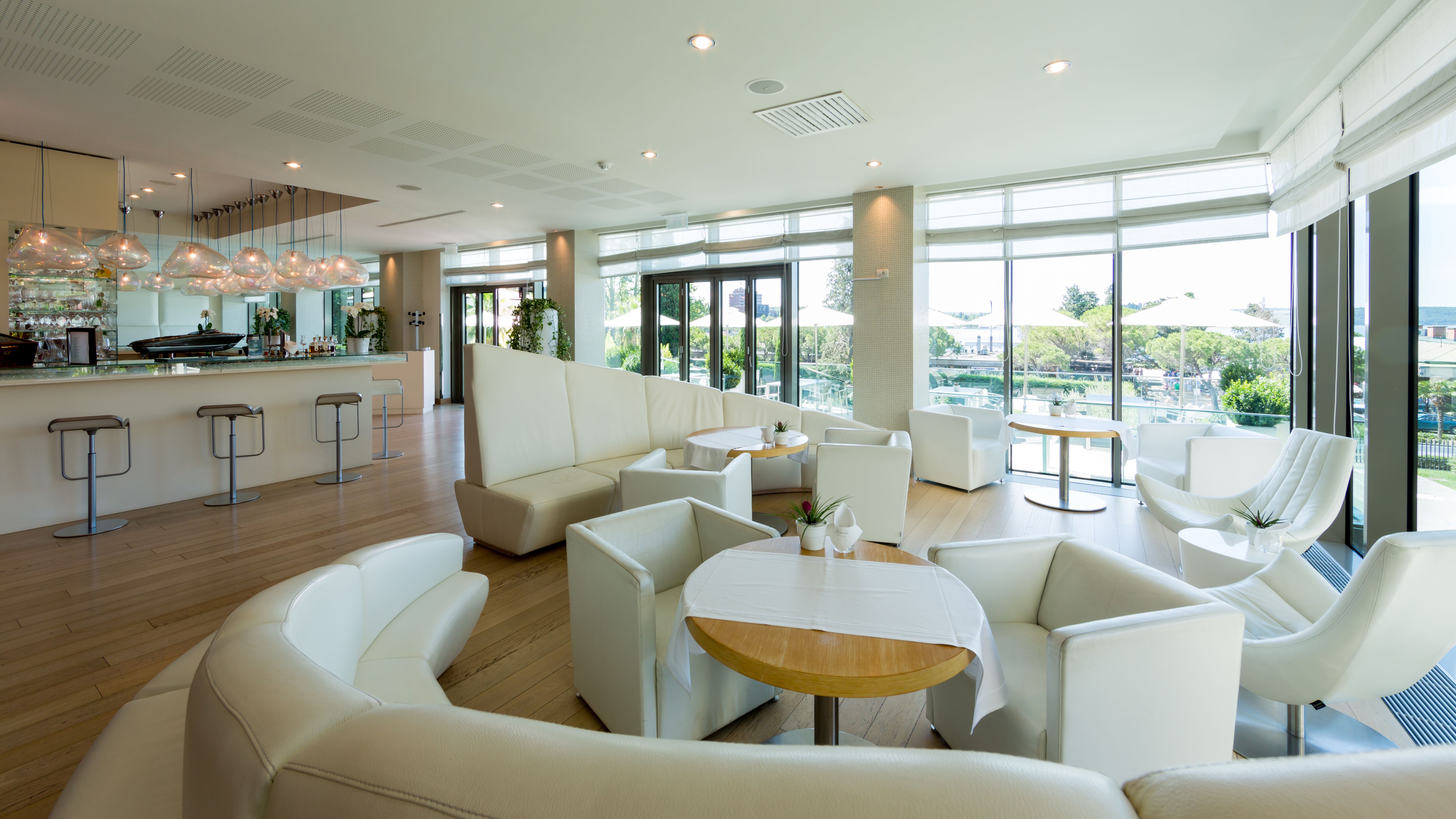 a room with white furniture and tables