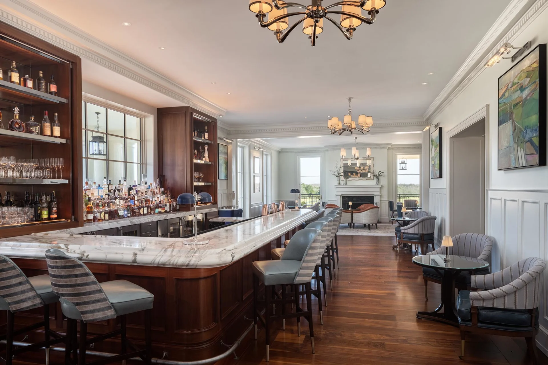a bar with a marble counter and chairs