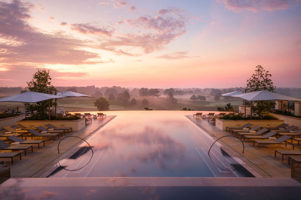 a pool with chairs and umbrellas on the side