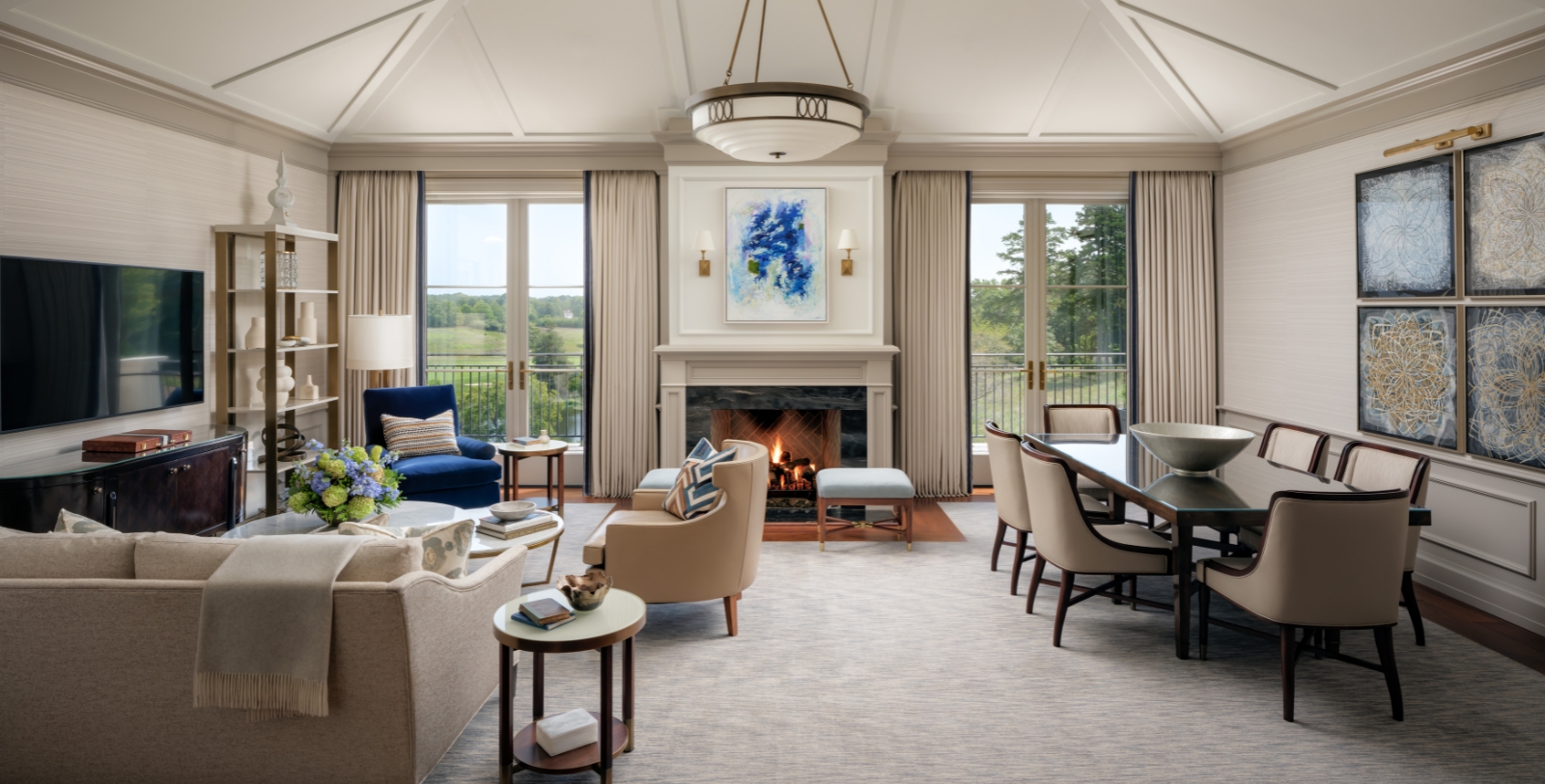 a living room with a fireplace and chairs