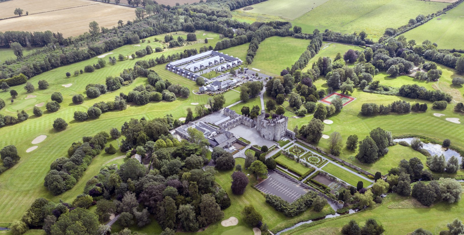 an aerial view of a castle and a park