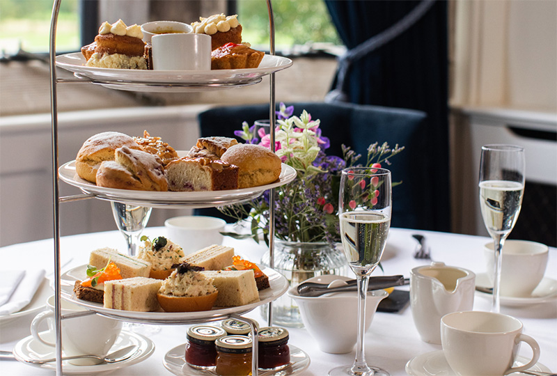 a three tiered tray with food on it