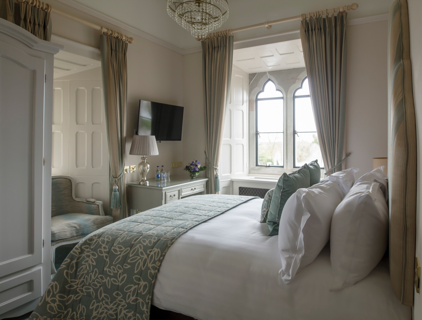 a bedroom with a bed and a chair