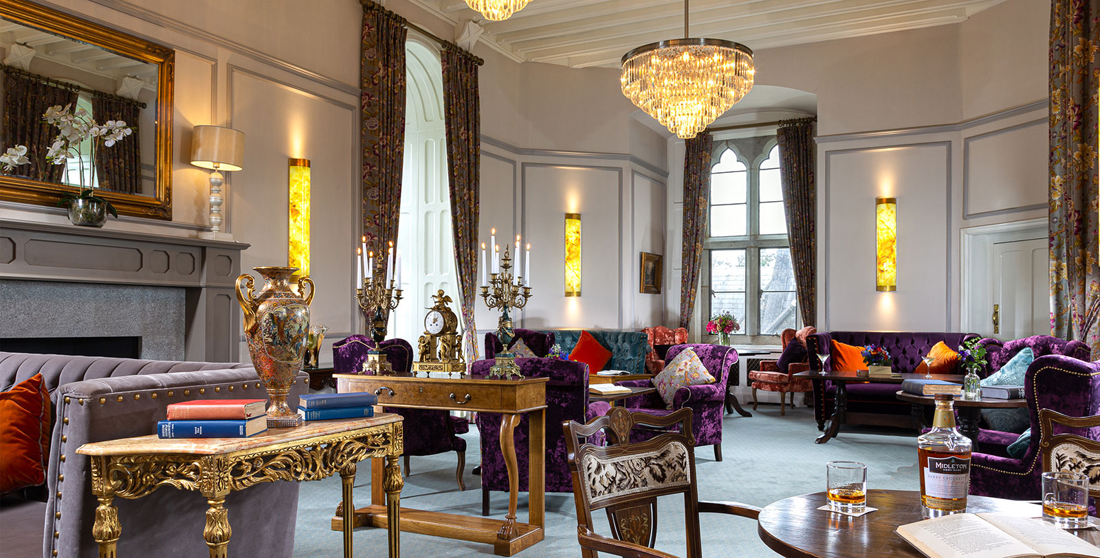 a room with a chandelier and couches