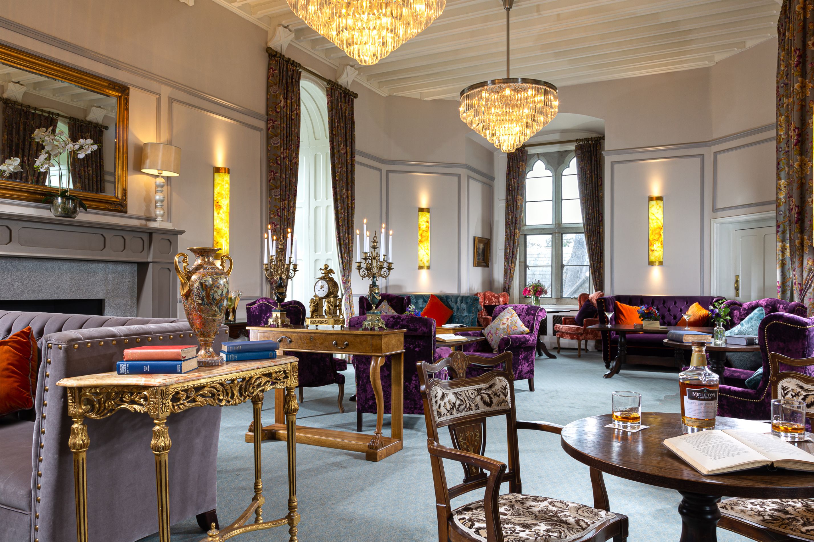 a room with a chandelier and couches