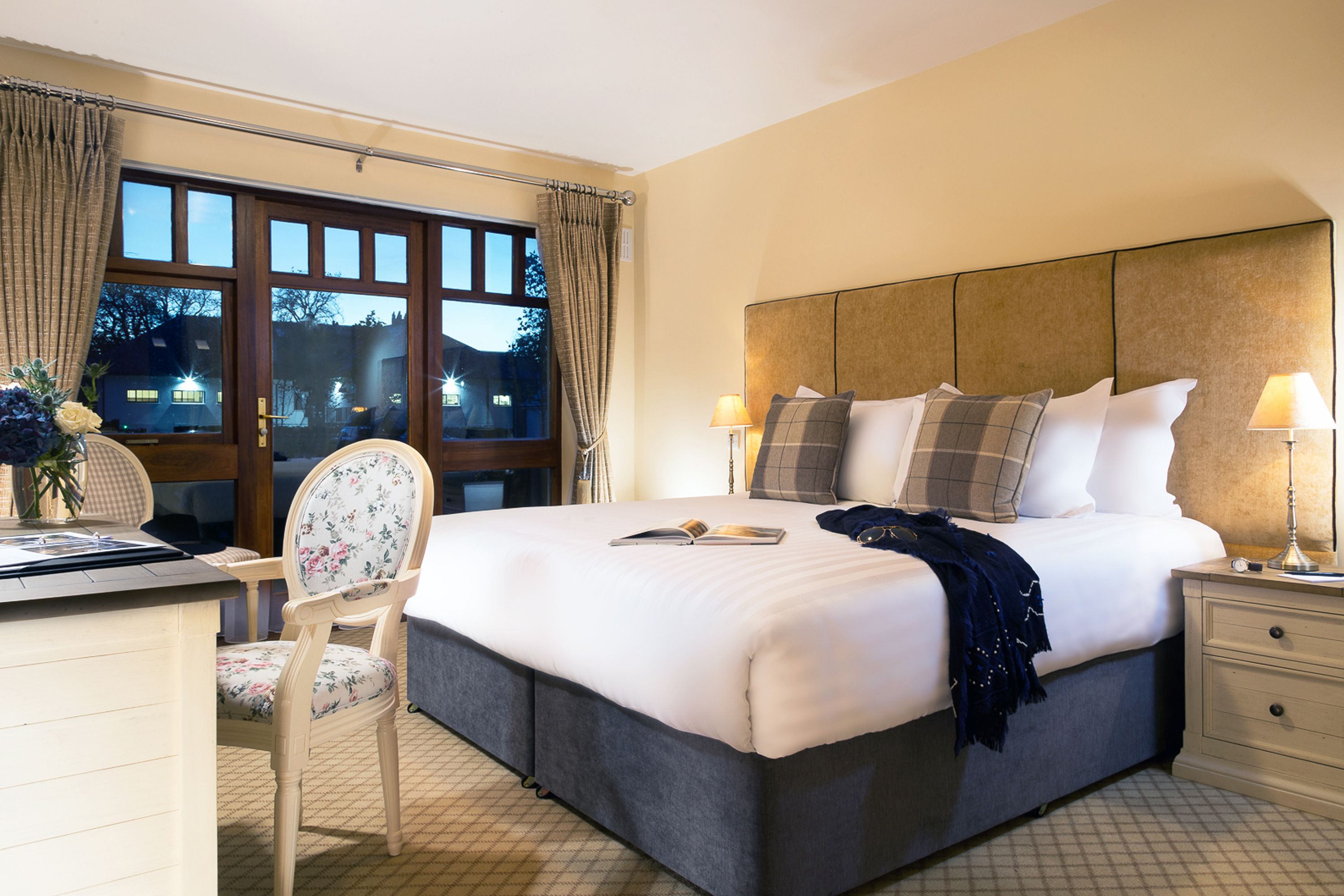 a bed with a chair and a table in a room