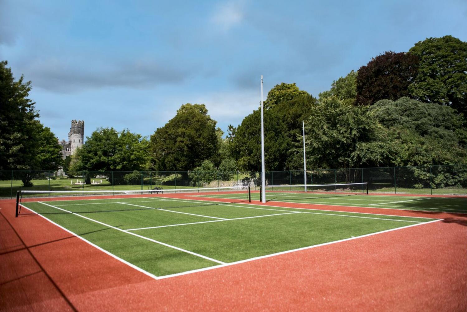a tennis court with a net and a pole