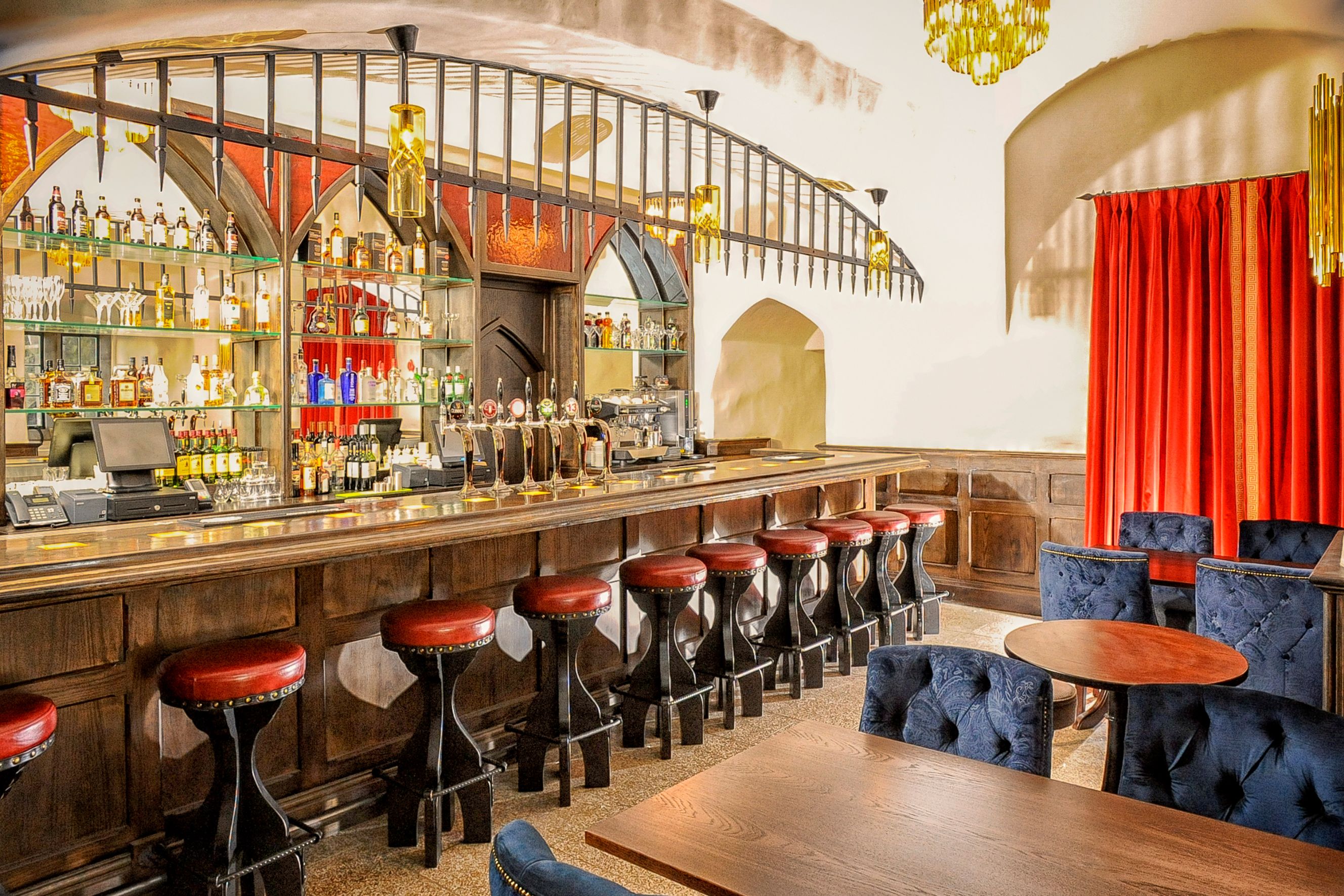 a bar with stools and tables