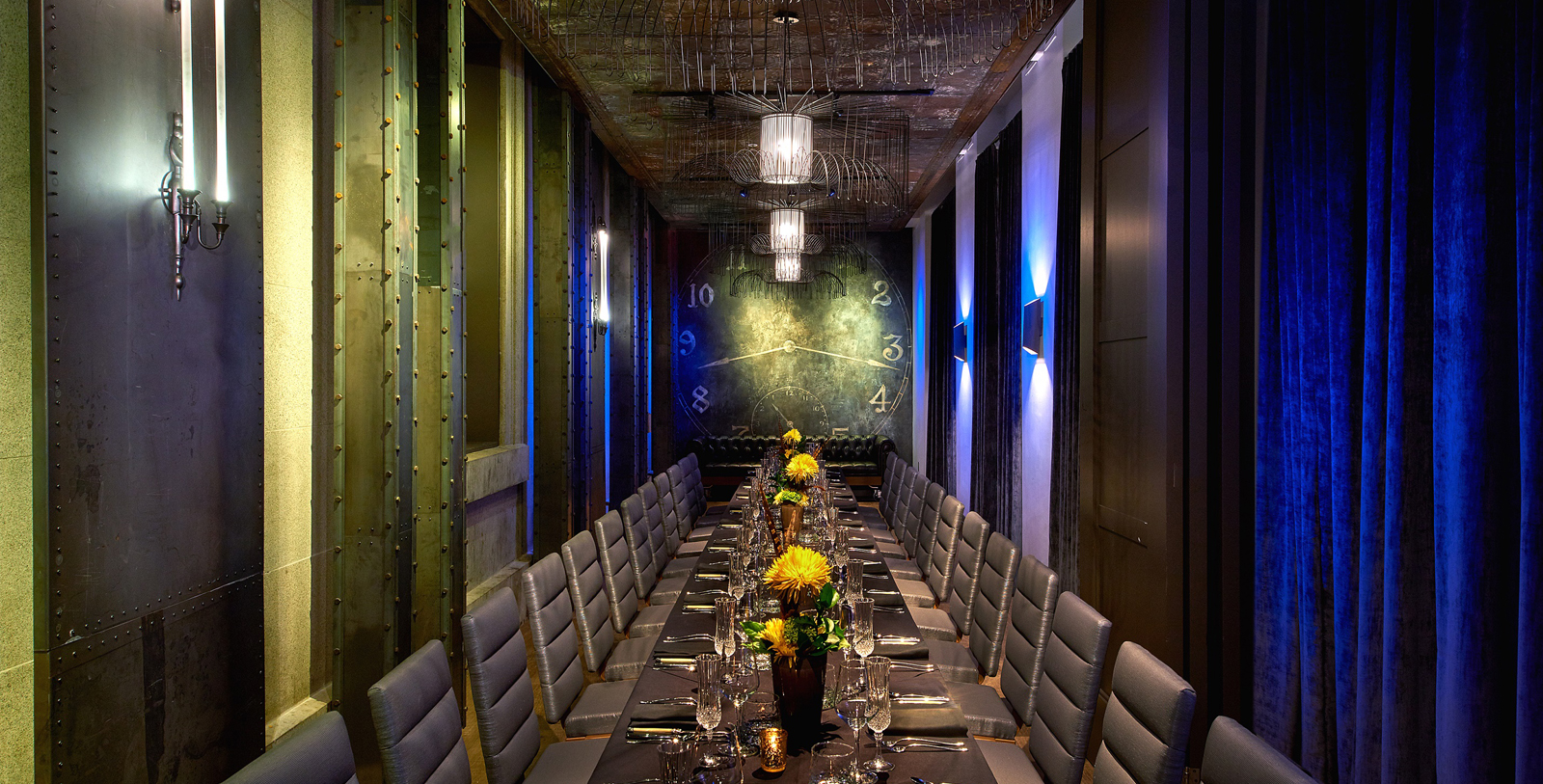 a long table with chairs and flowers