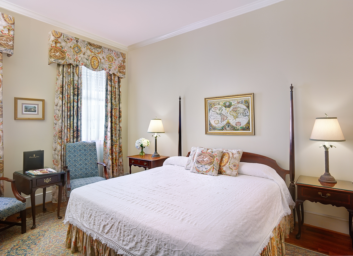 a bed with a lamp and a chair in a room