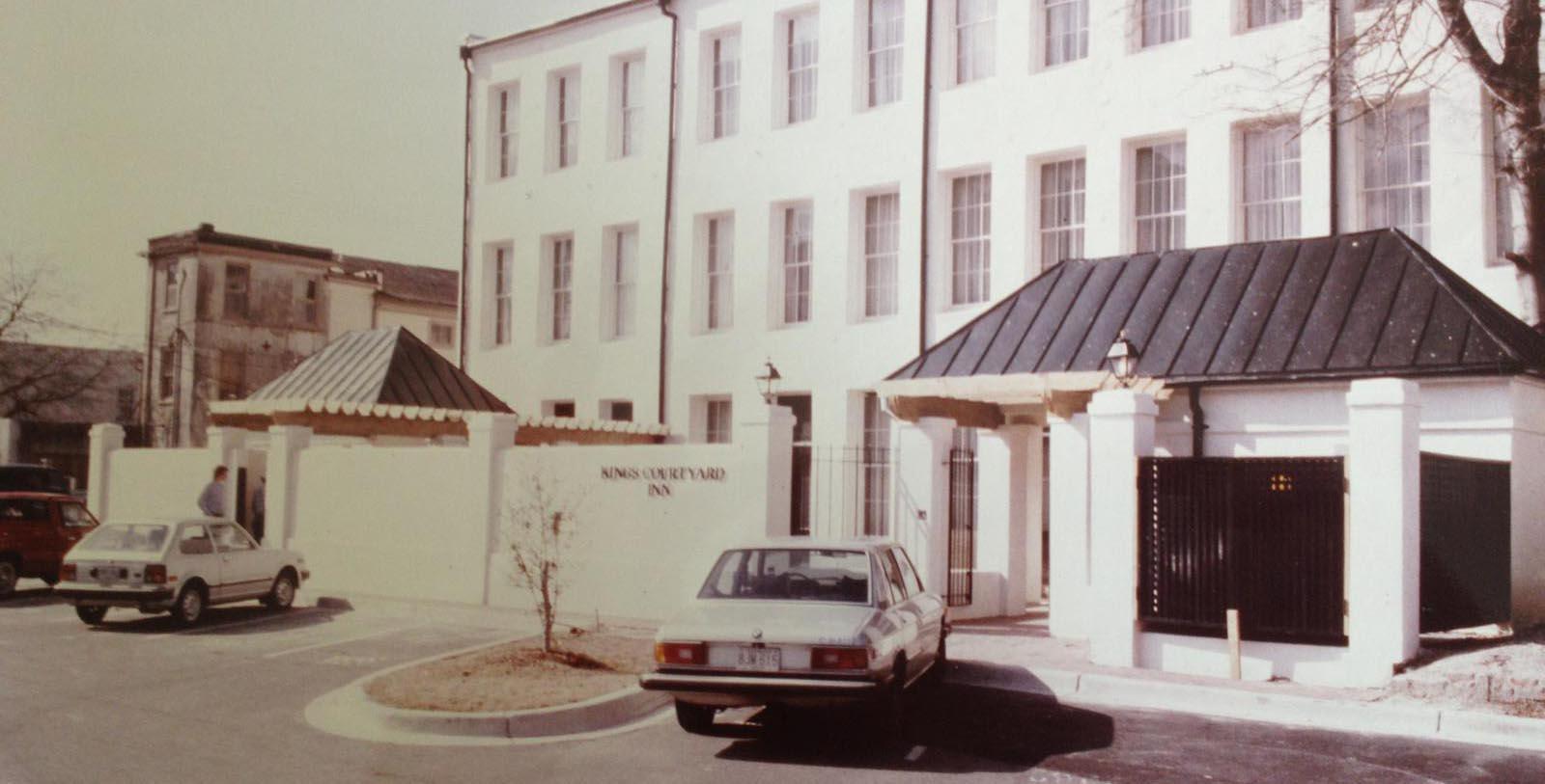 a car parked in front of a white building