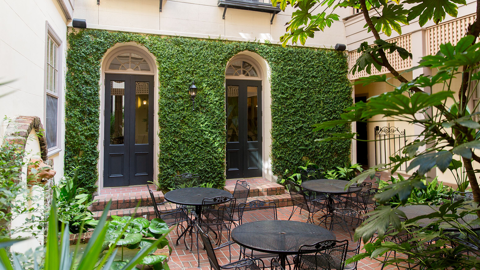 a patio with tables and chairs outside of a building