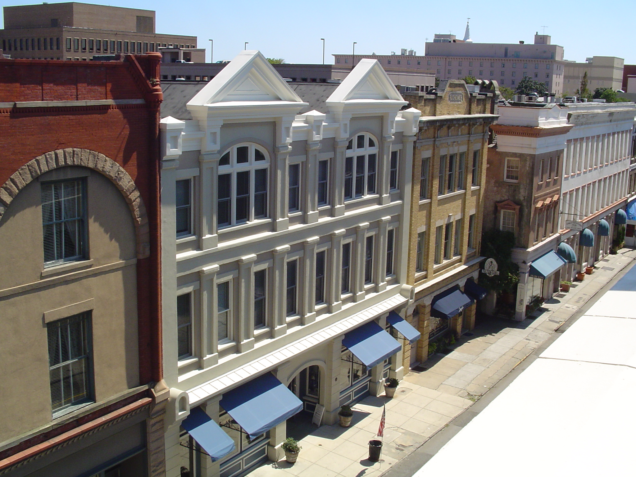 a row of buildings with blue awnings