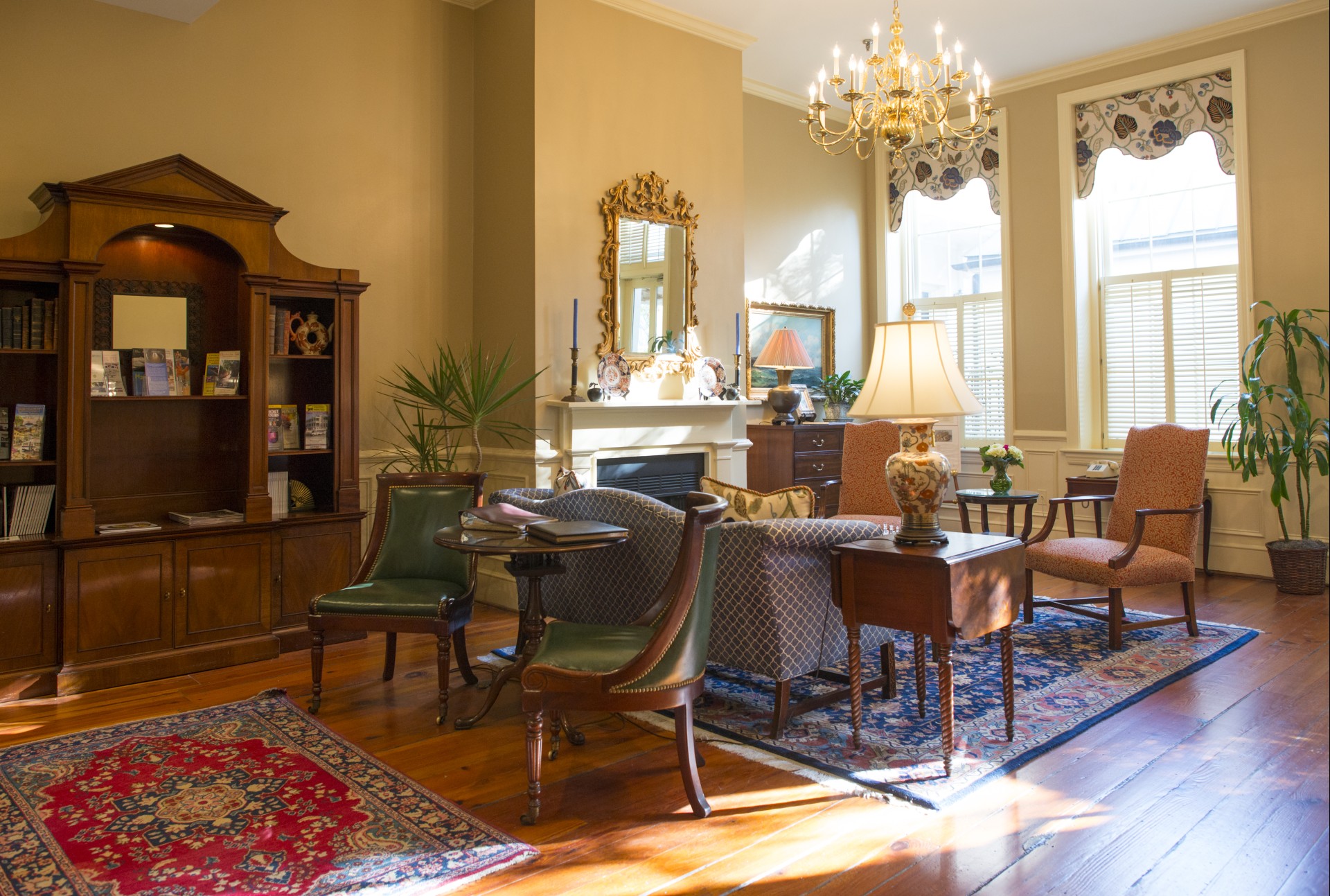 a living room with a fireplace and chairs