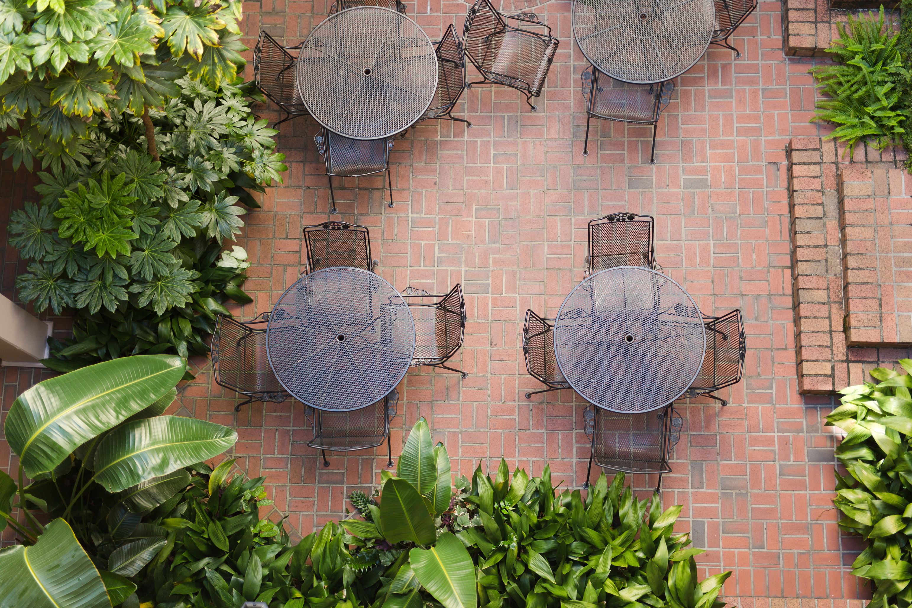 a group of tables and chairs on a brick patio