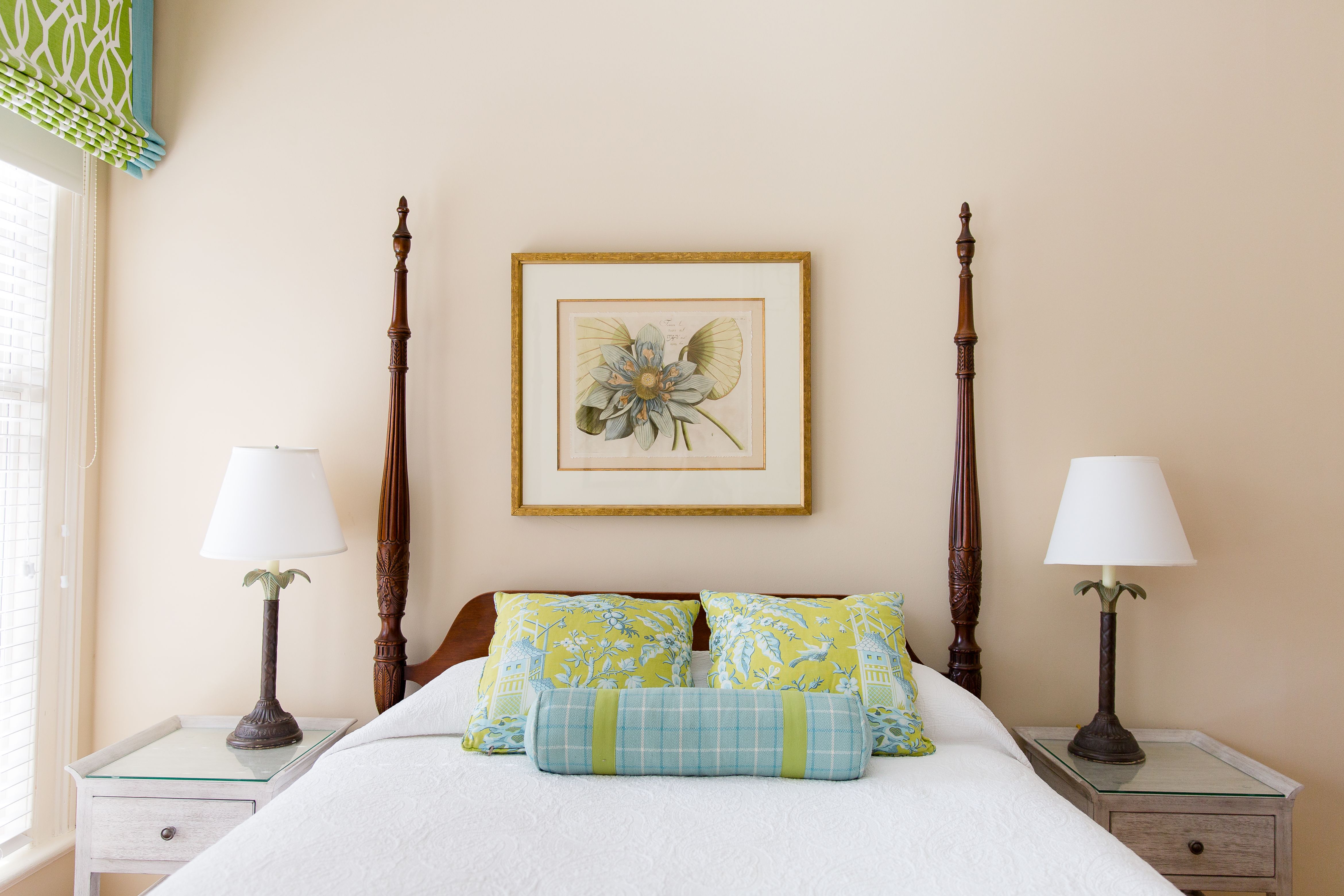 a bed with two lamps above it