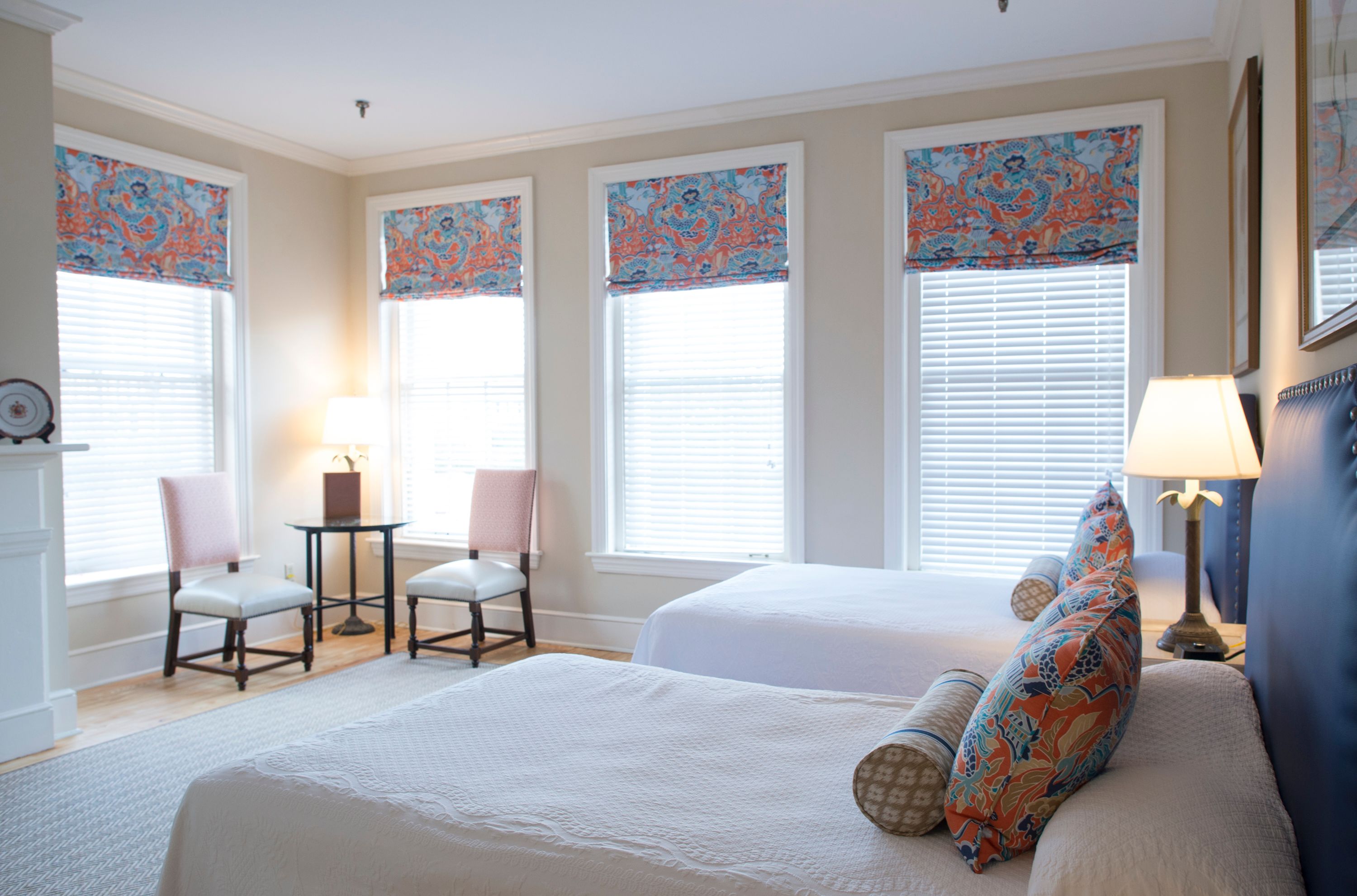 a room with two beds and a lamp