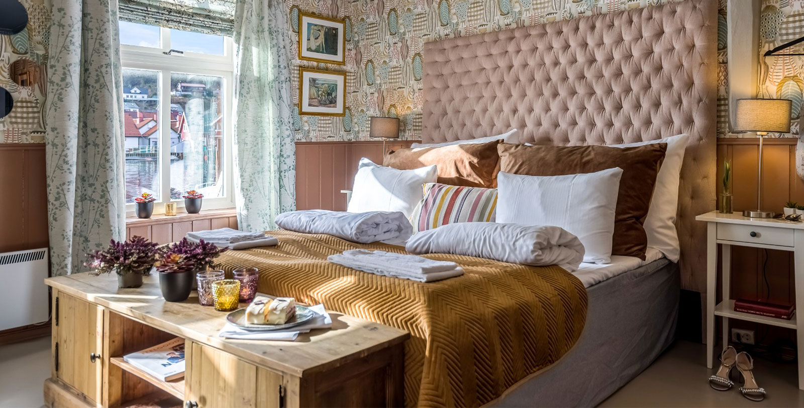 a bed with pillows and blankets on it