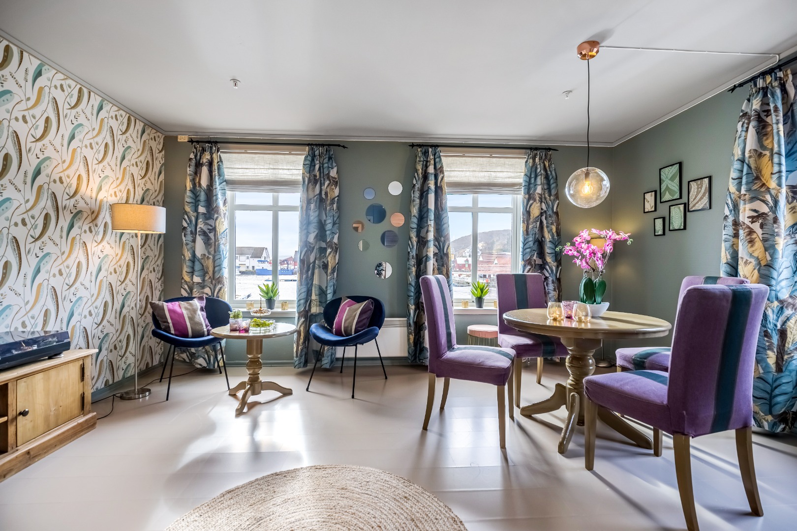 a room with purple chairs and tables