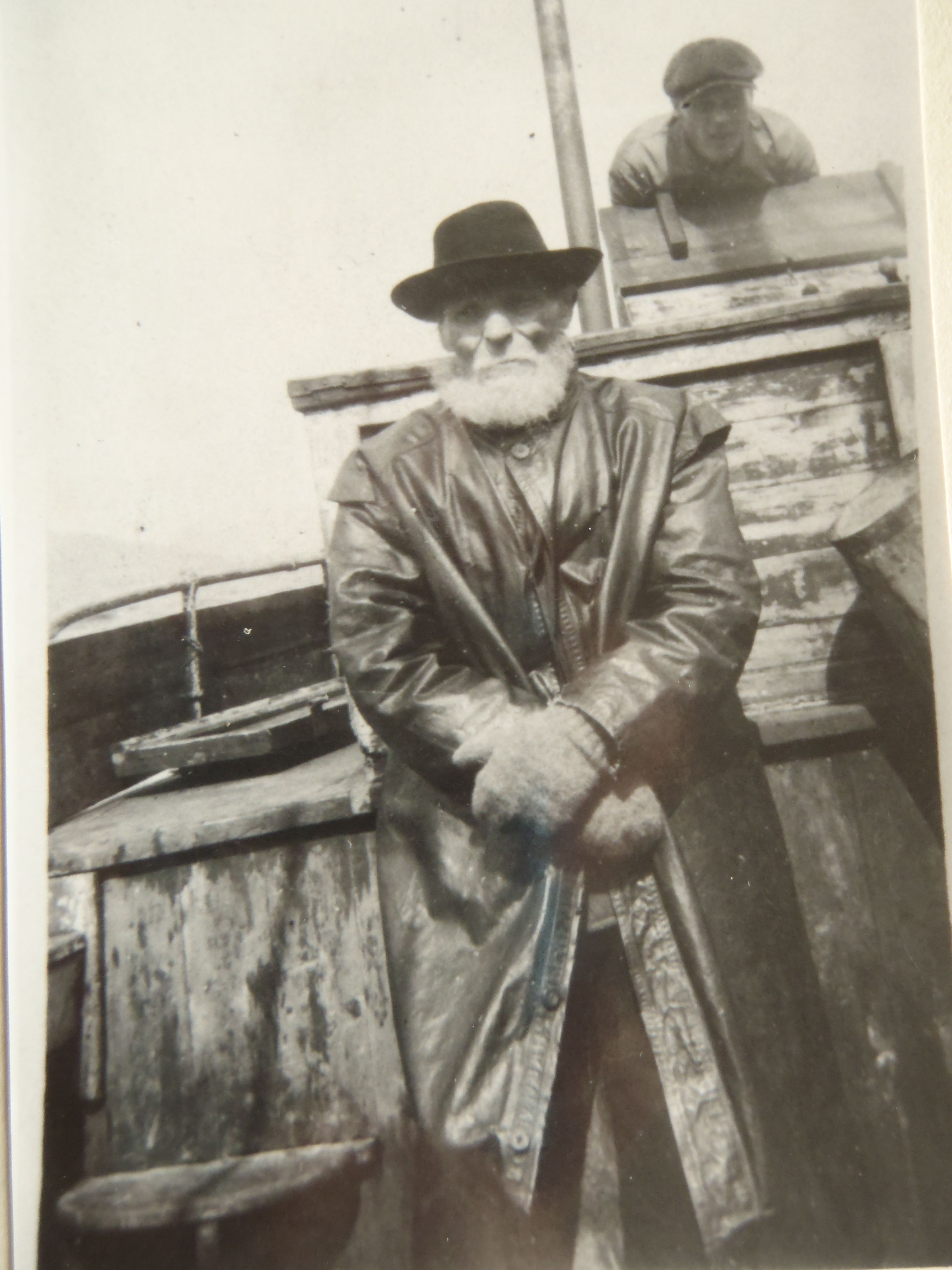 a man in a hat and a long coat