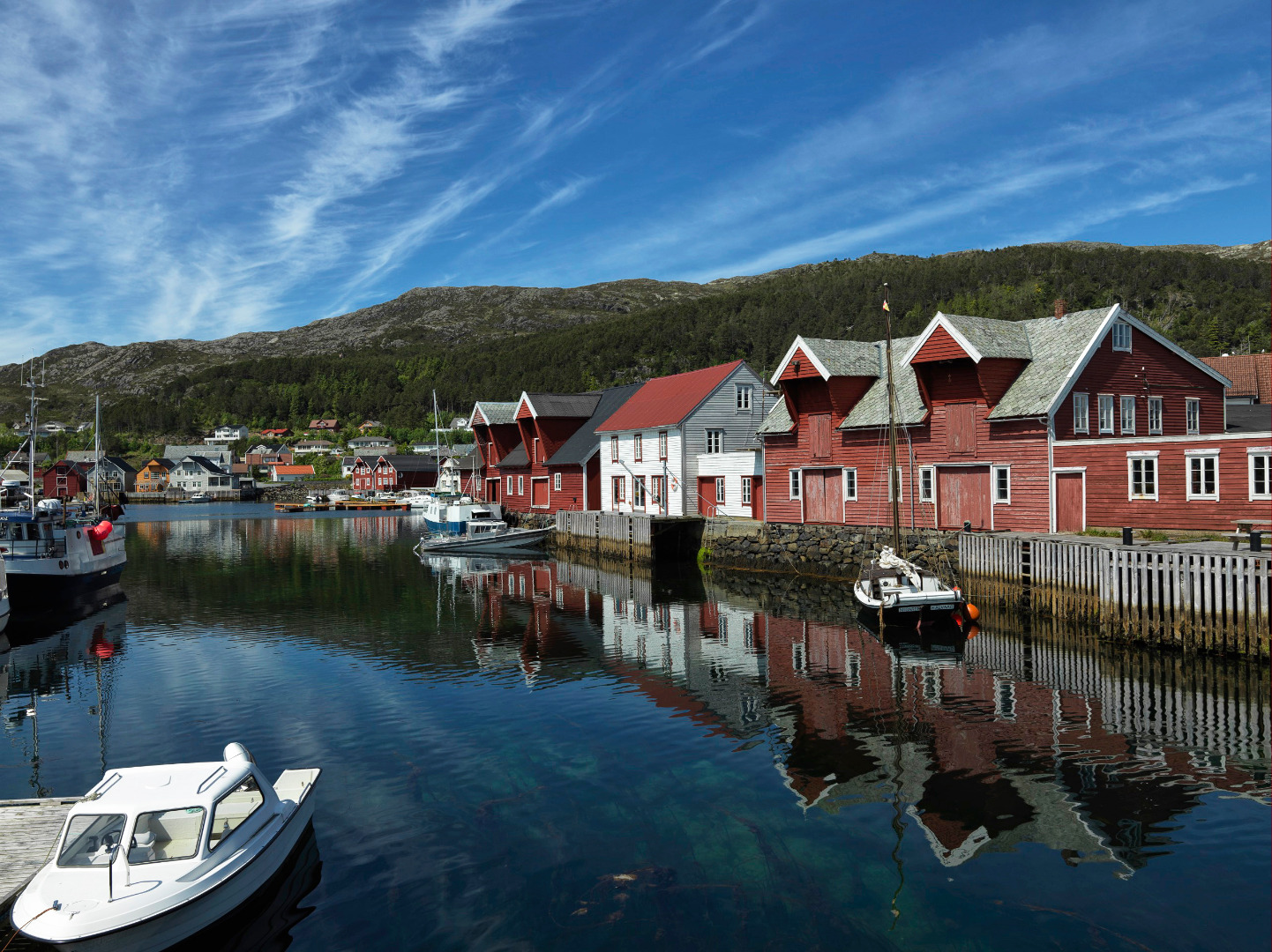 a body of water with boats and buildings in the background