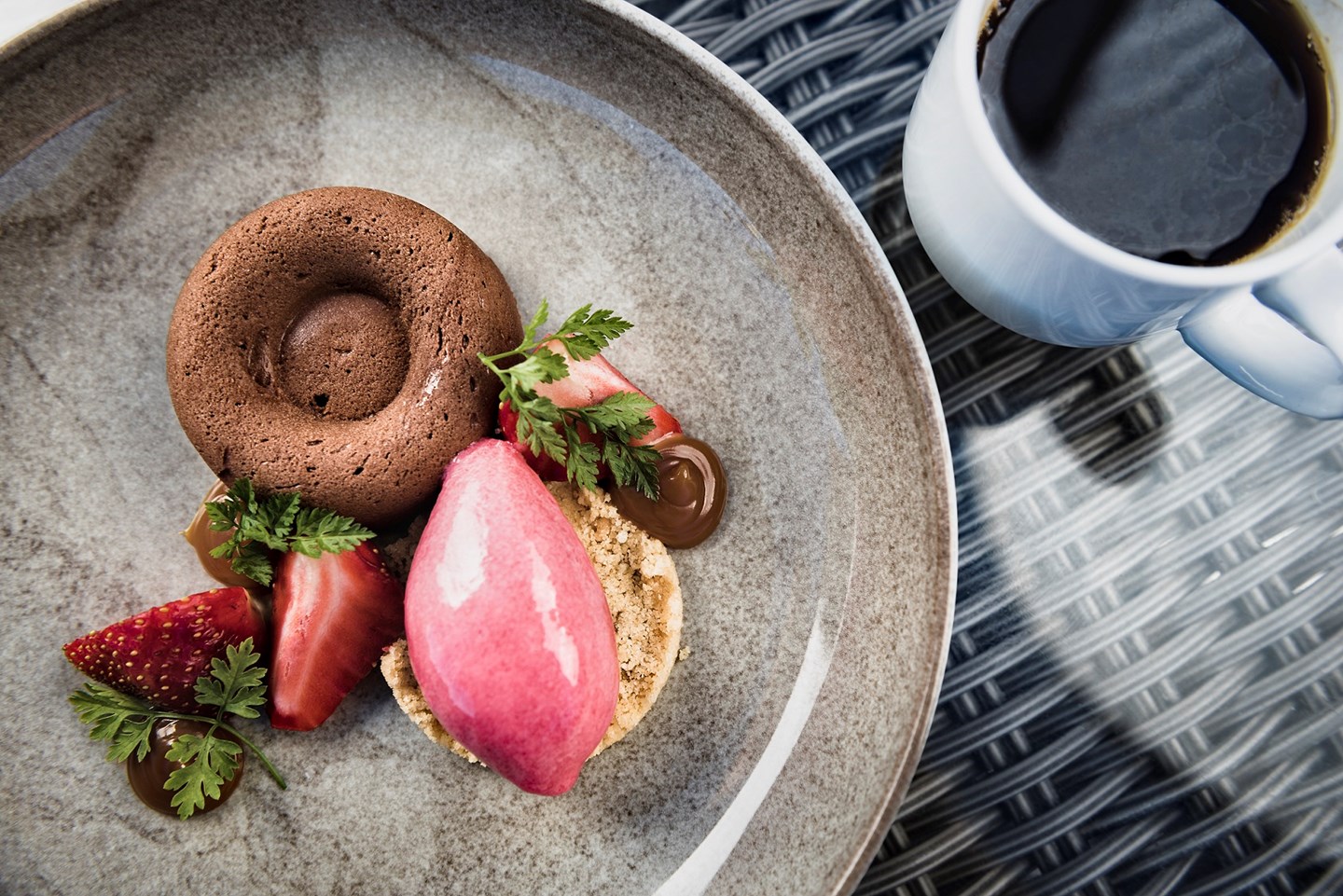 a plate of dessert with a cup of coffee
