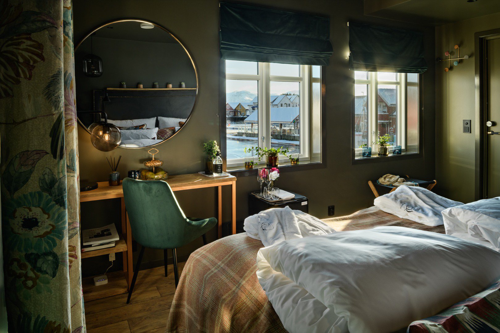 a room with a mirror and a bed
