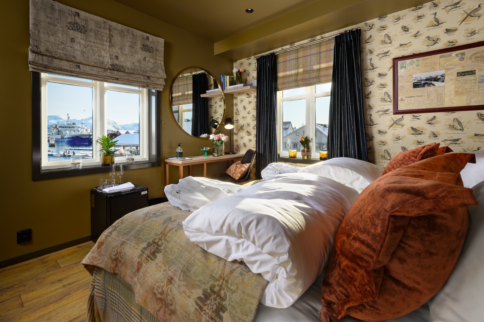 a bedroom with a bed and a mirror