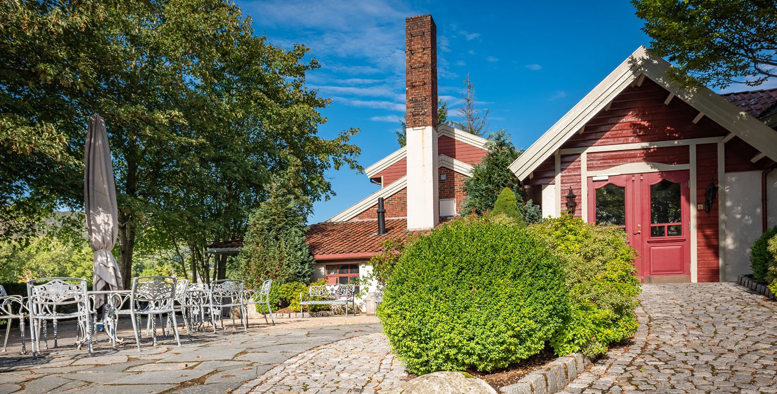 a house with a brick chimney and a garden