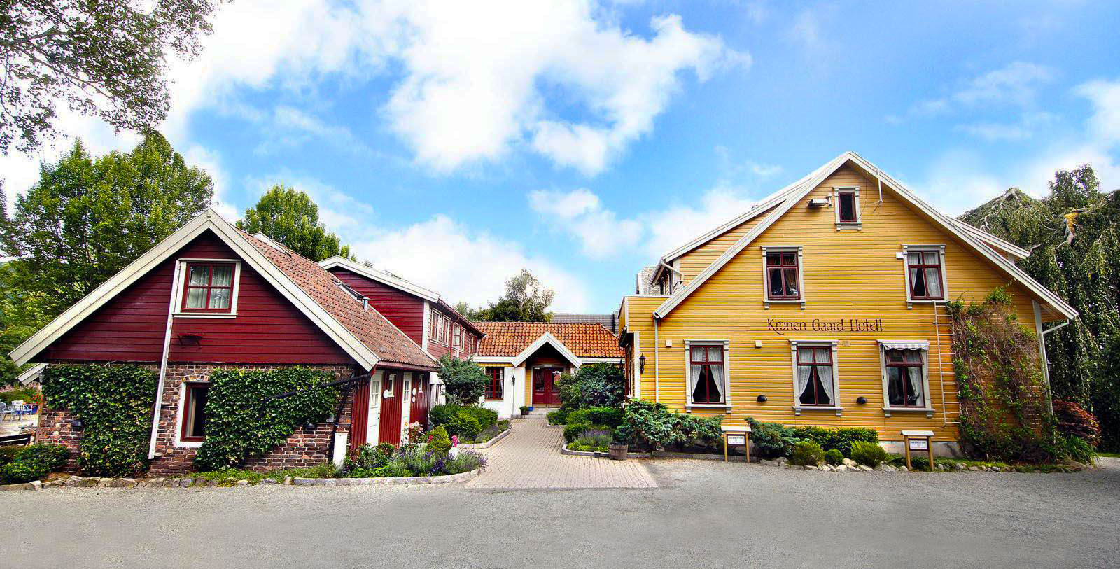 a group of houses with bushes and trees