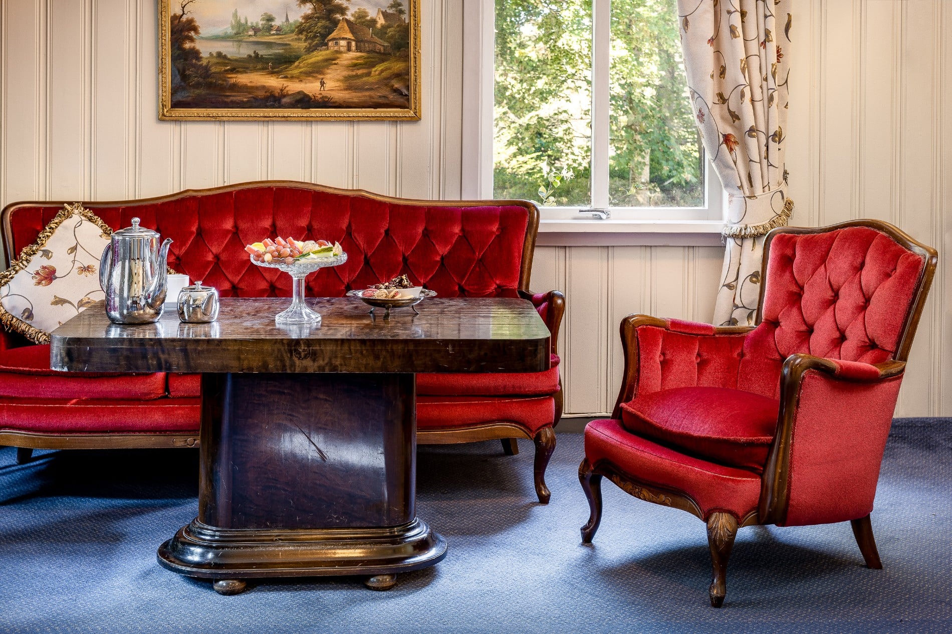 a room with red couches and red chairs