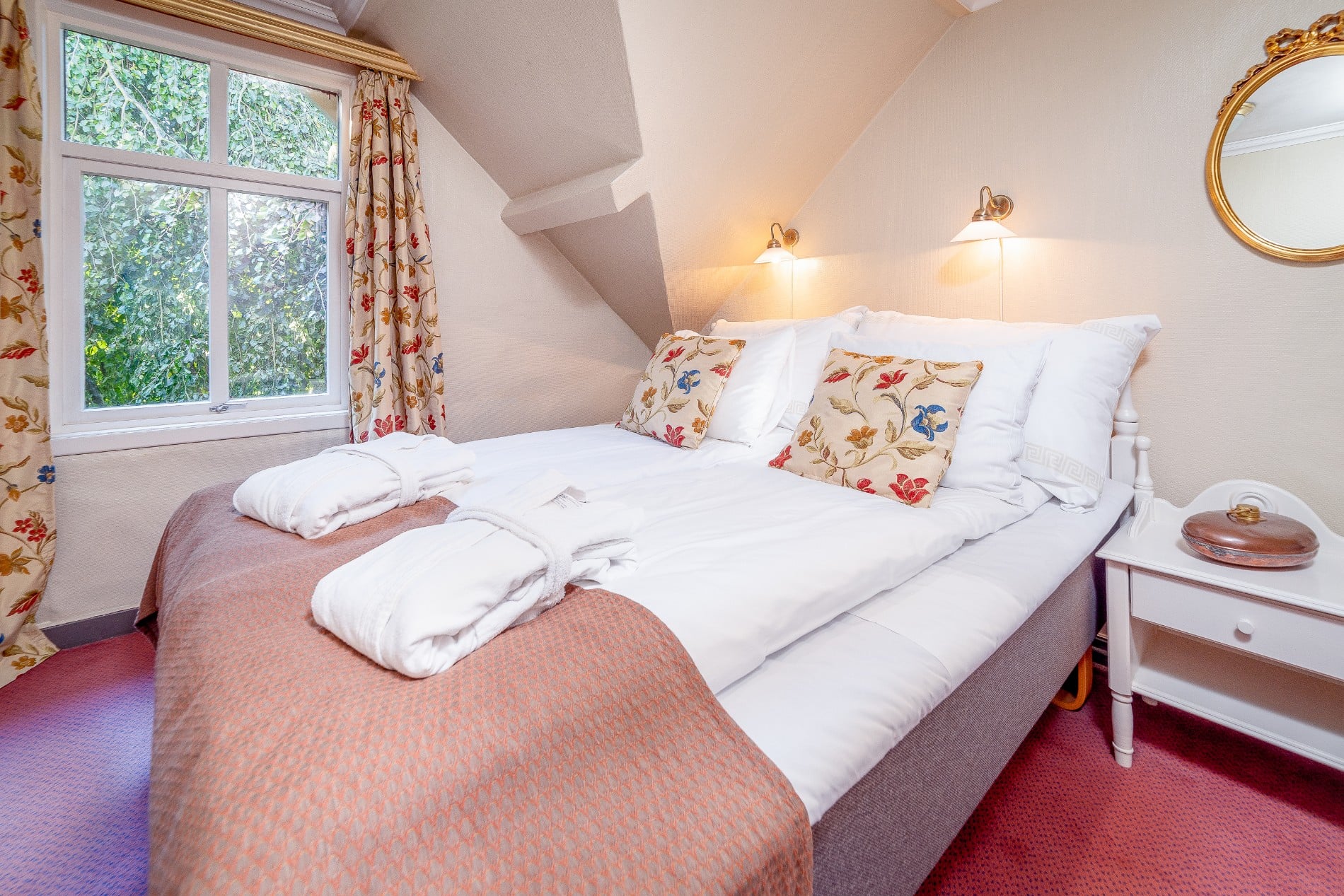 a bed with pillows and towels in a room