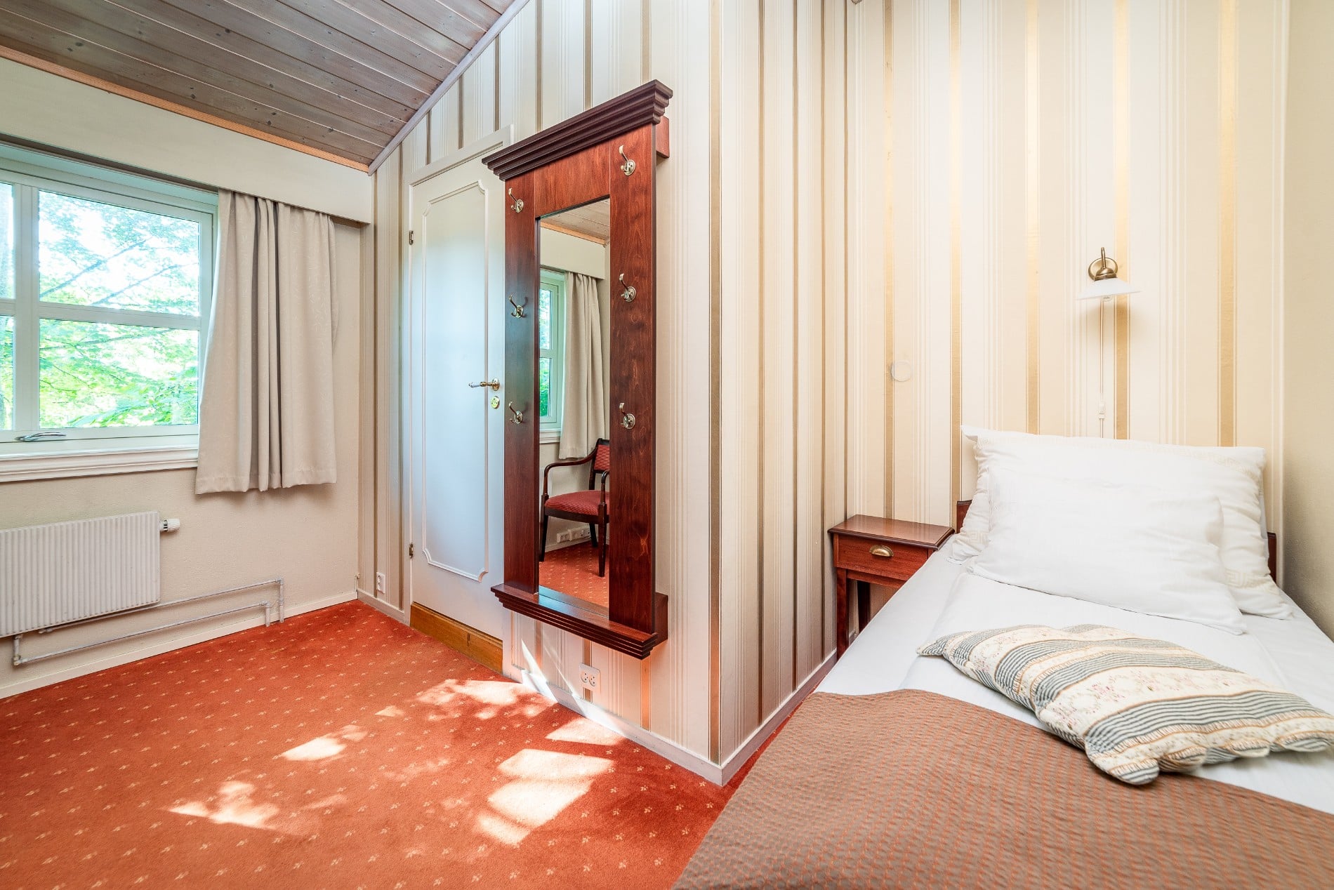 a bedroom with a mirror and a bed