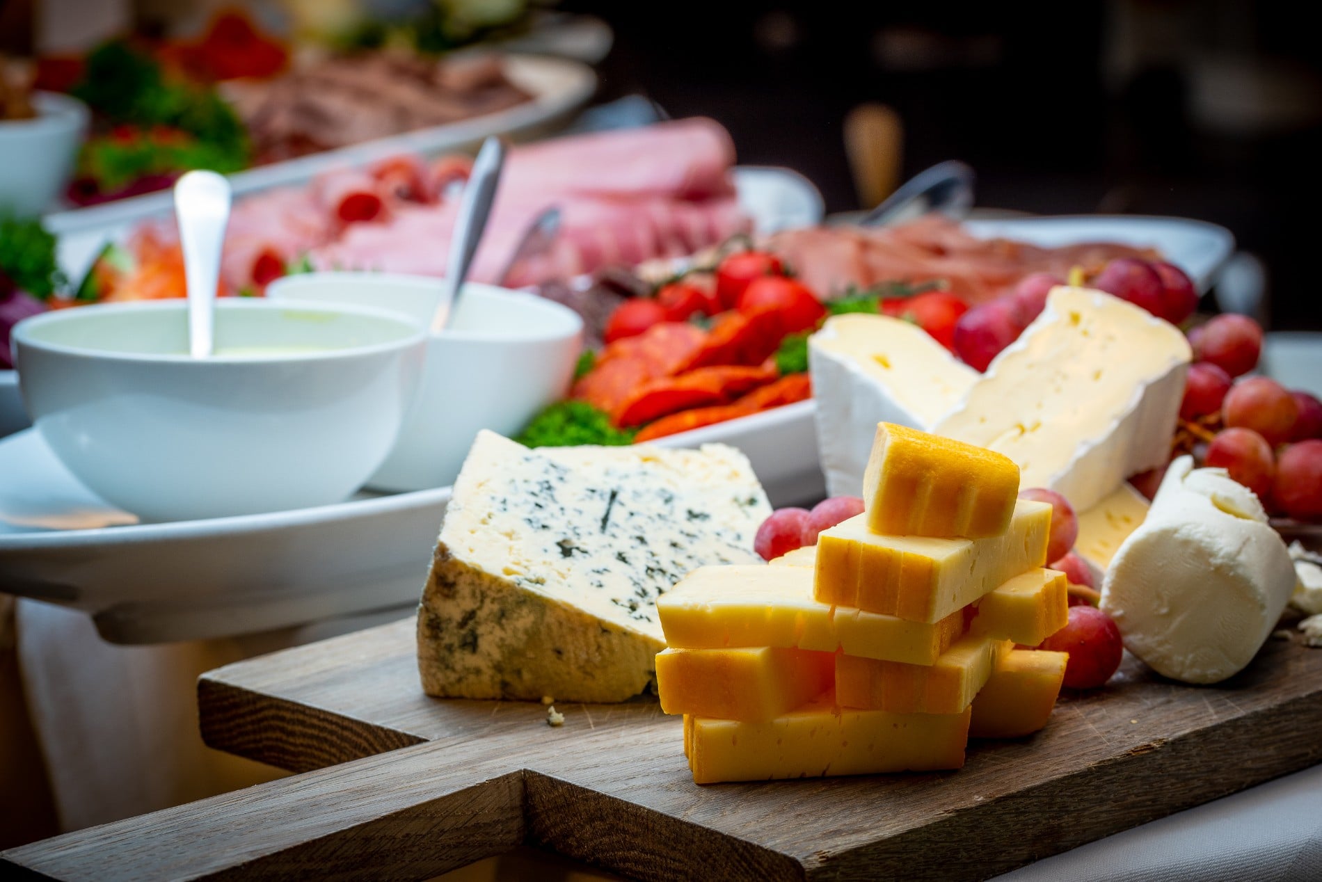 a board with different types of cheese on it