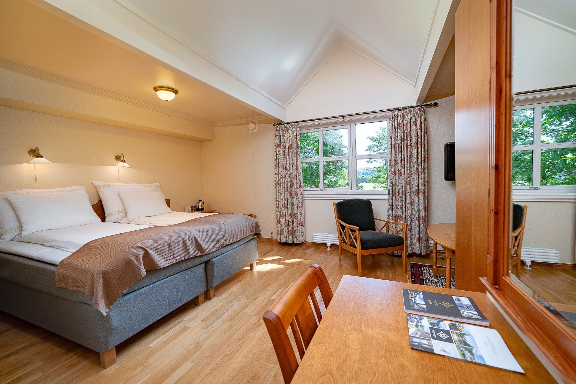 a bedroom with a bed and a table and chairs