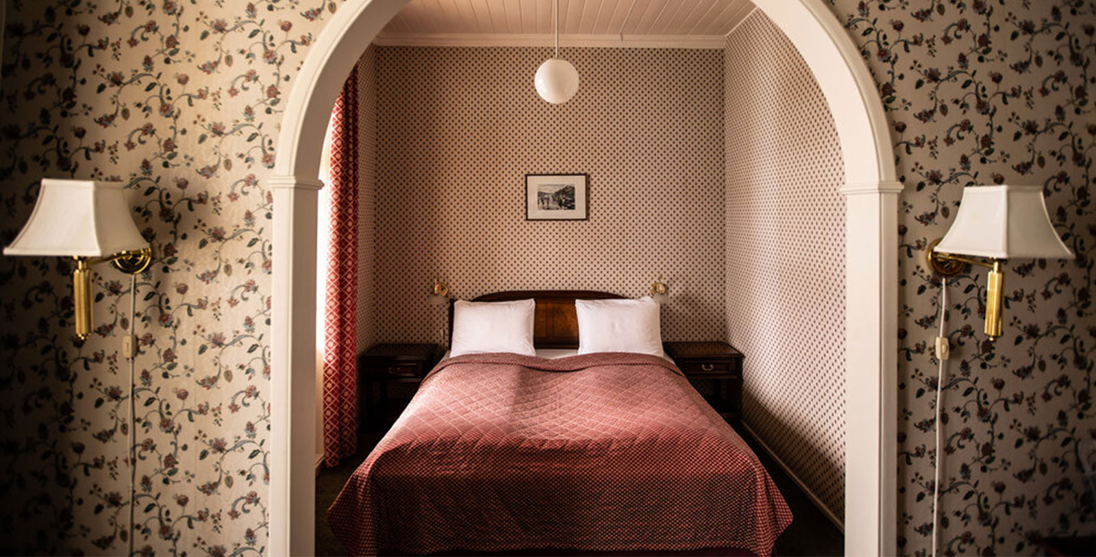 a bed with pillows in a room