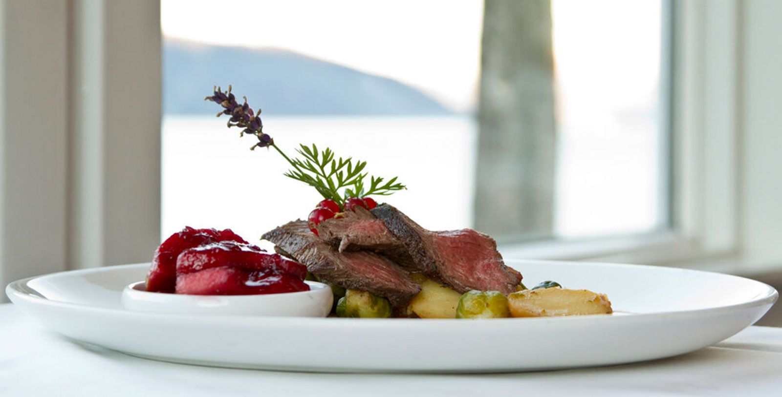 a plate of food with a plant on top