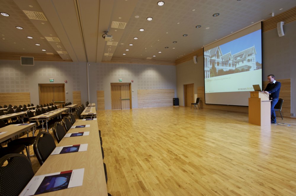 a room with a large projector screen