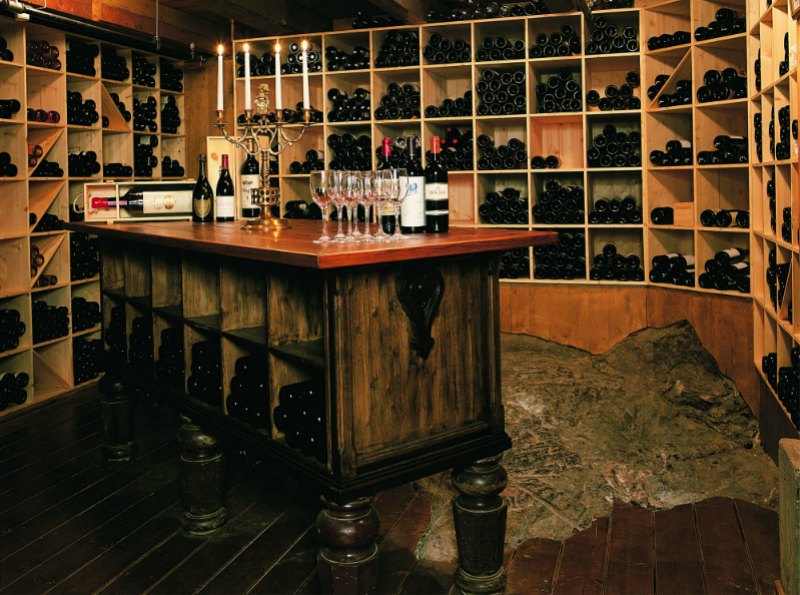 a wine cellar with wine glasses and bottles