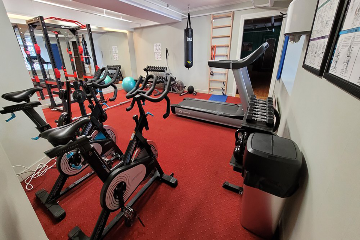 a room with exercise bikes and a punching bag