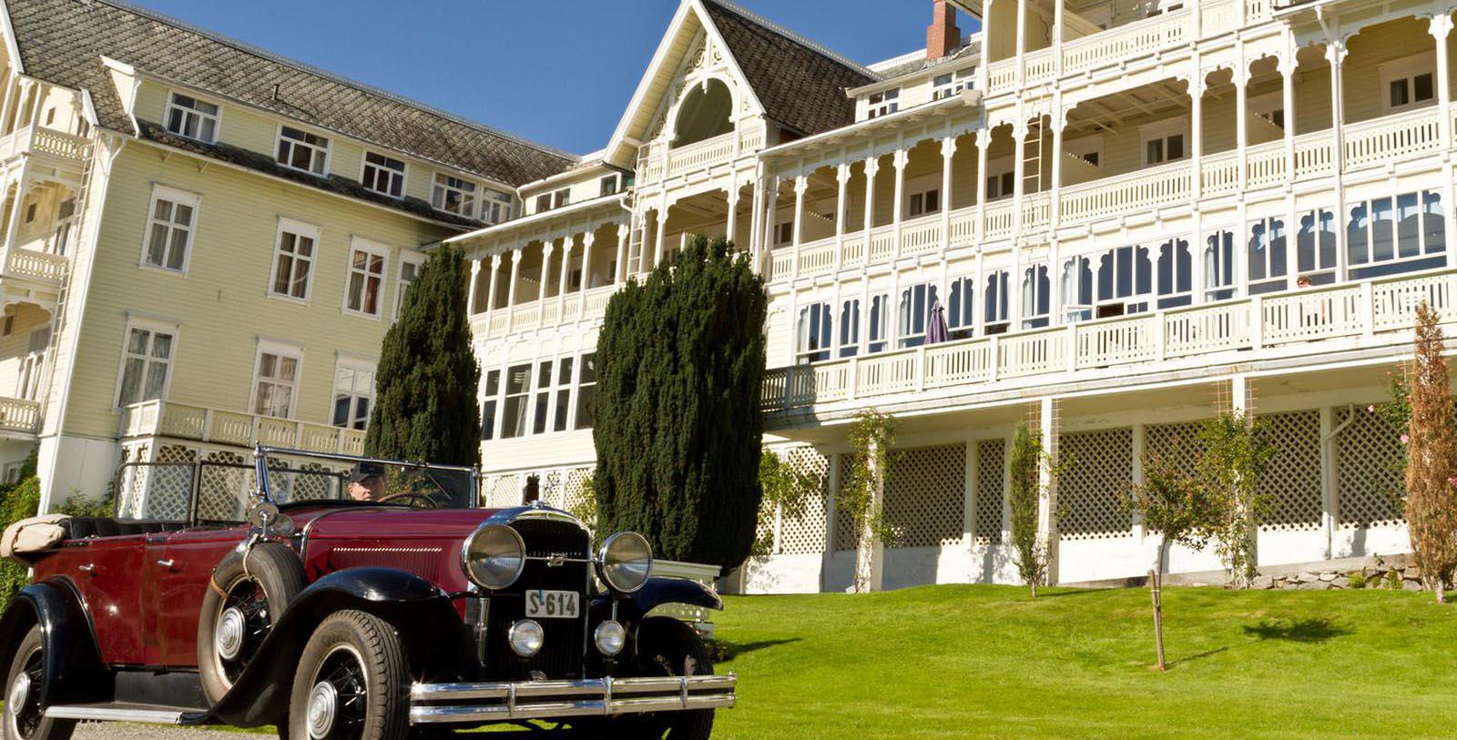 a car parked in front of a white building