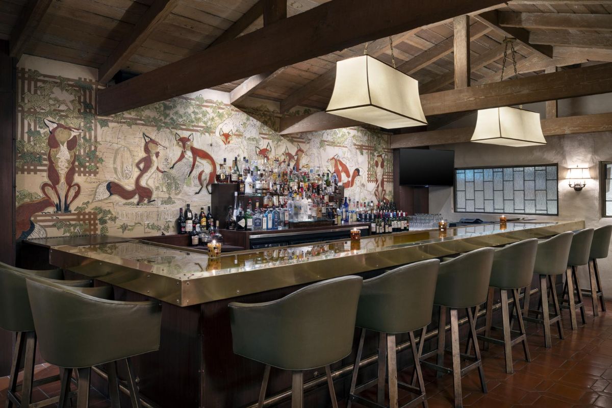 a bar with a bar and chairs