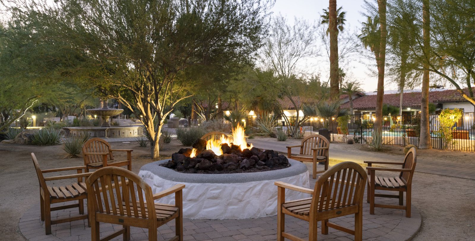 a fire pit with chairs around it