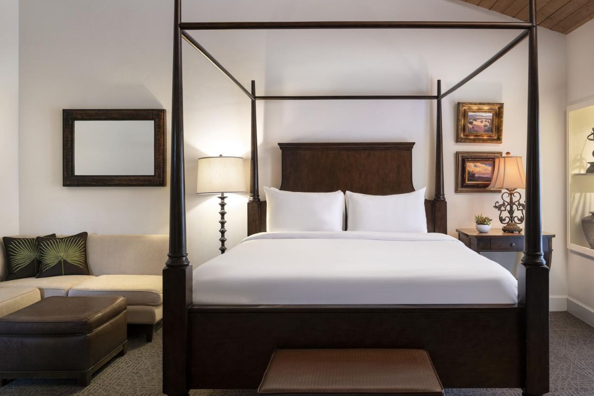 a bed with a four poster bed