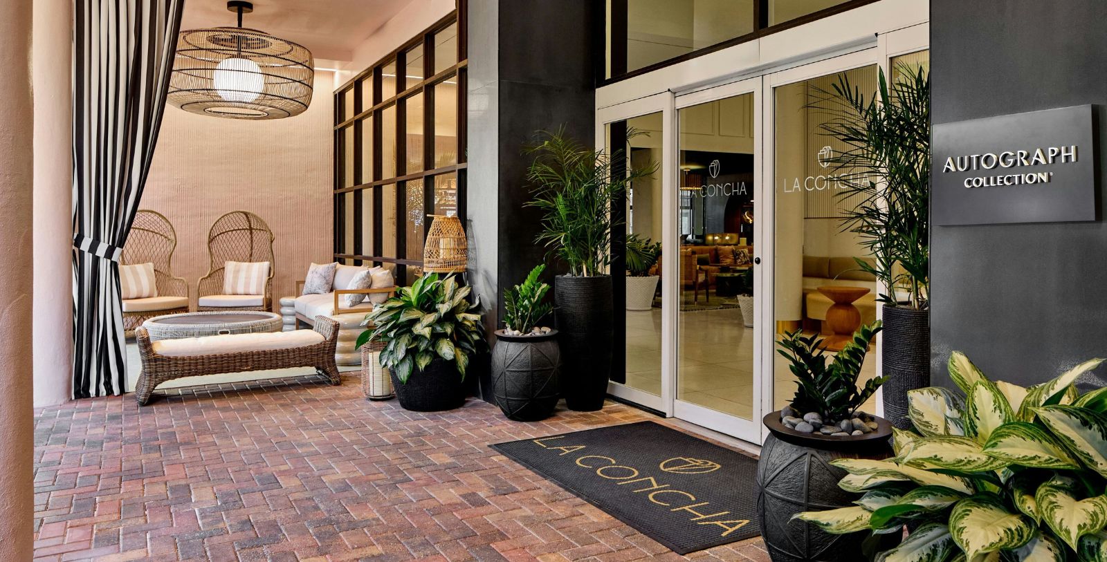 a patio with plants and a doormat