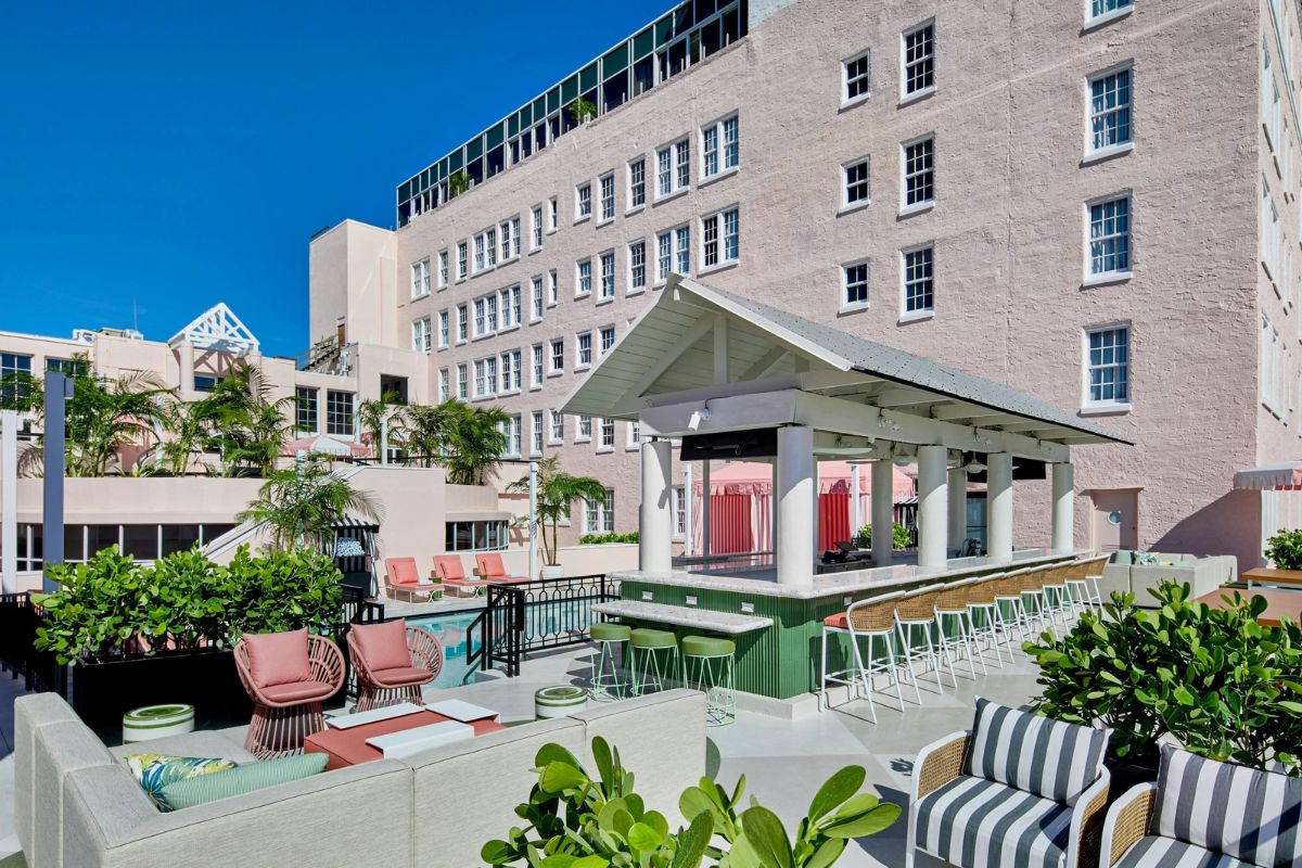 a building with a pool and chairs